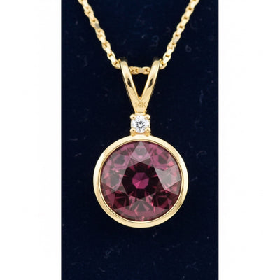 dije de oro 14k con granate rhodolita purpureo rosa natural 1.29ct corte redonda de Africa, joyería mexicana Gold Shield