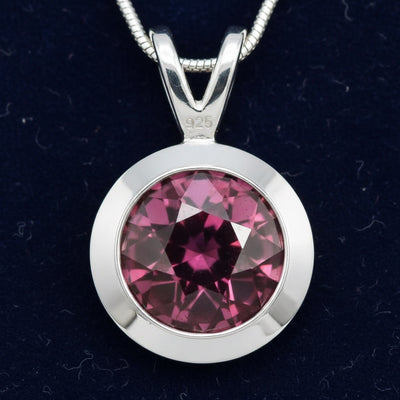 dije de plata 925 con granate rhodolita purpureo rosa natural 1.29ct corte redonda de Africa, joyería mexicana Gold Shield
