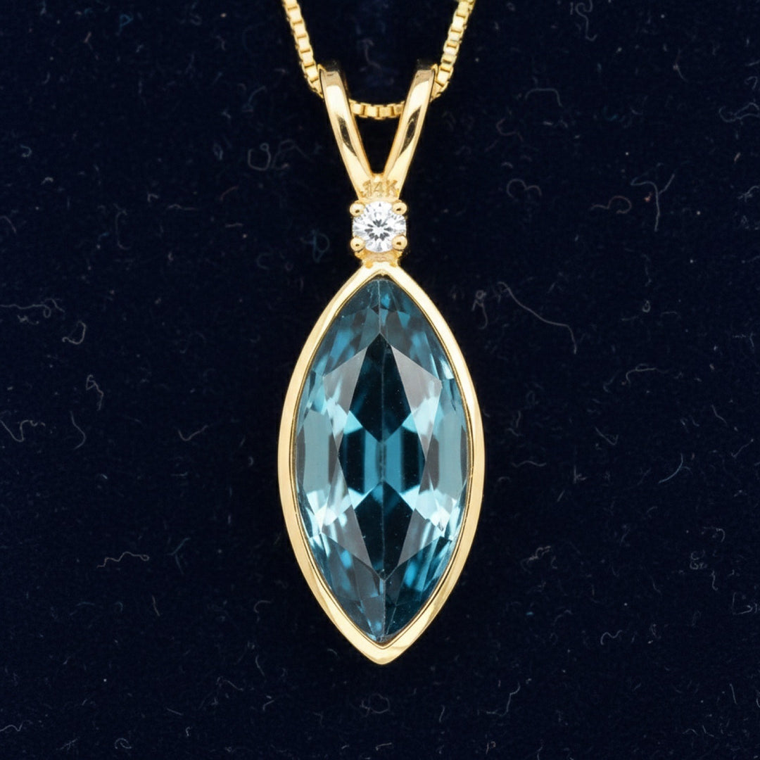 dije de oro 14k con topacio london blue natural 0.89ct corte marquesa de Brasil, joyería mexicana Gold Shield