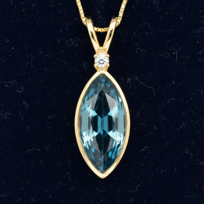 dije de oro 14k con topacio london blue natural 0.89ct corte marquesa de Brasil, joyería mexicana Gold Shield