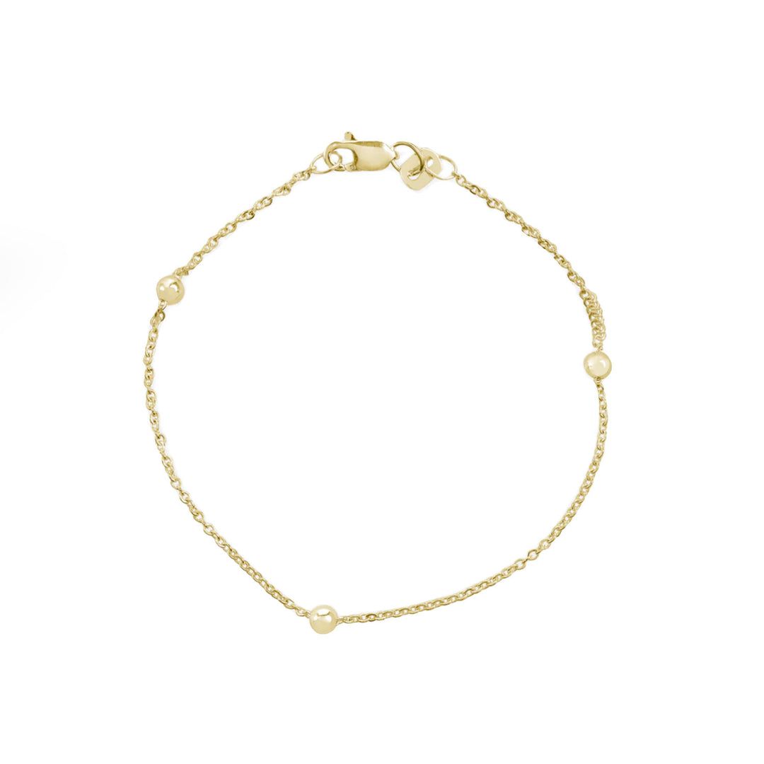 Pulsera de oro bolitas fondo blanco - GOLD SHIELD